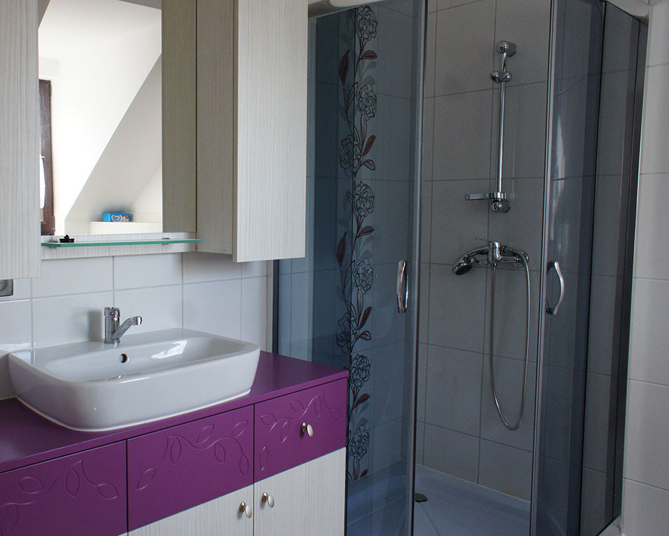 Fioletowe akcenty w łazience z frezem w kształcie łodyg i liści, łazienka z meblami na wymiar